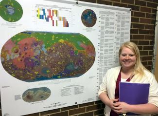 UGA Geology Graduate Student, Laura Mackrell, before her poster on on the project “Mapping Minerals in Margartifiter Terra, Mars”