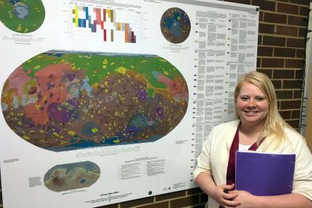 UGA Geology Graduate Student, Laura Mackrell, before her poster on on the project “Mapping Minerals in Margartifiter Terra, Mars”